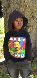 Participant in the 2022 MLK Jr. Day celebration wearing a black hoodie with Dr. King's visage